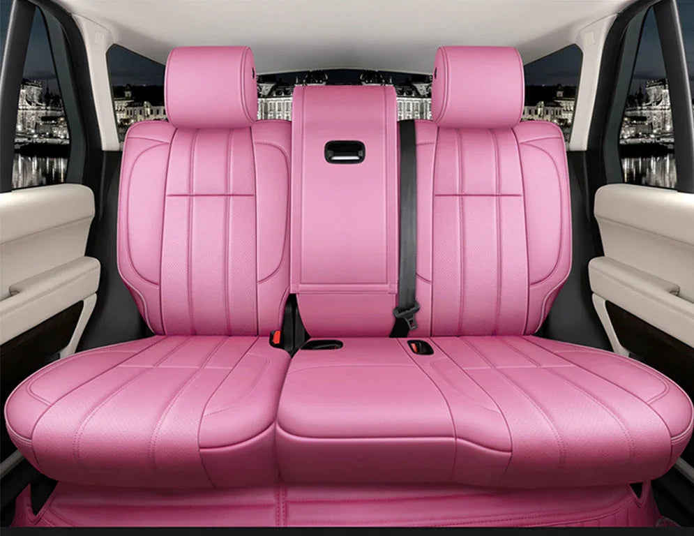 Backseat of luxury car with vibrant pink leather upholstery and beige interior panels
