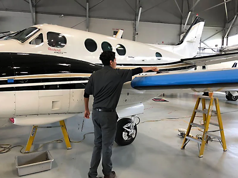 Professional aircraft detailing specialist polishing private jet exterior