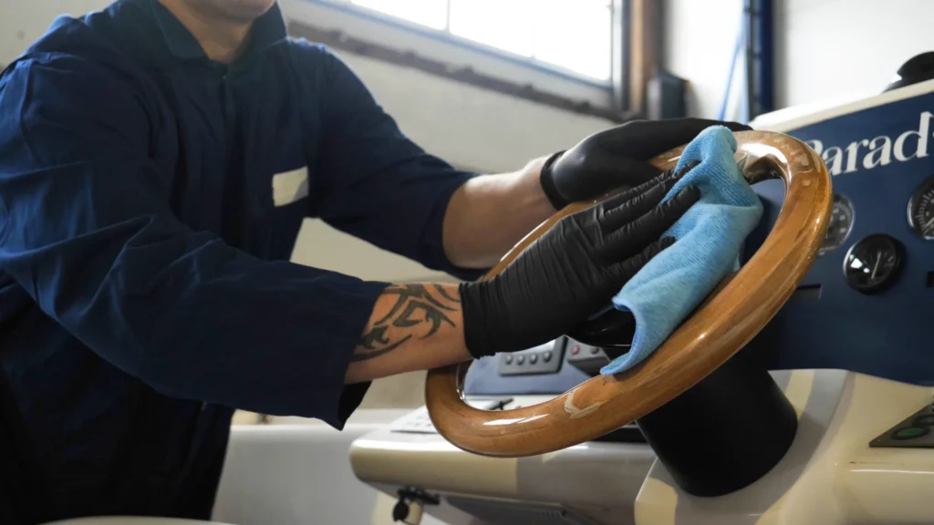 Boat interior detailing in Orleans cleaning and polishing marine steering wheel and dashboard surfaces