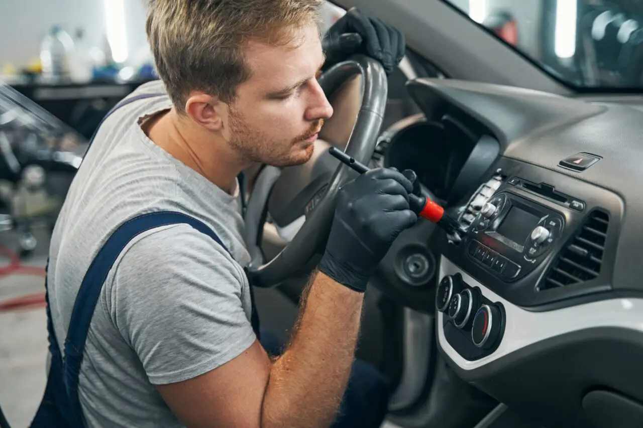 chemical-wash-of-car-dashboard-with-foam-and-brush-interior-detailing