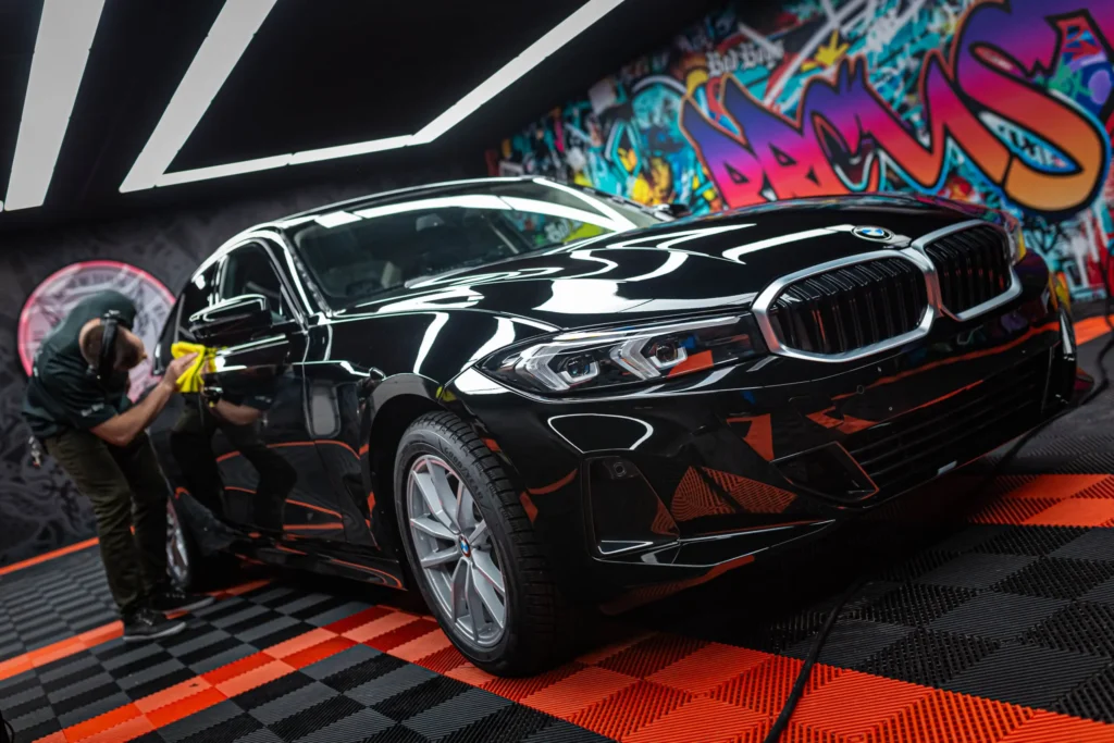 Paint Correction & Polishing in Orleans on black BMW sedan restoring deep gloss and swirl-free finish
